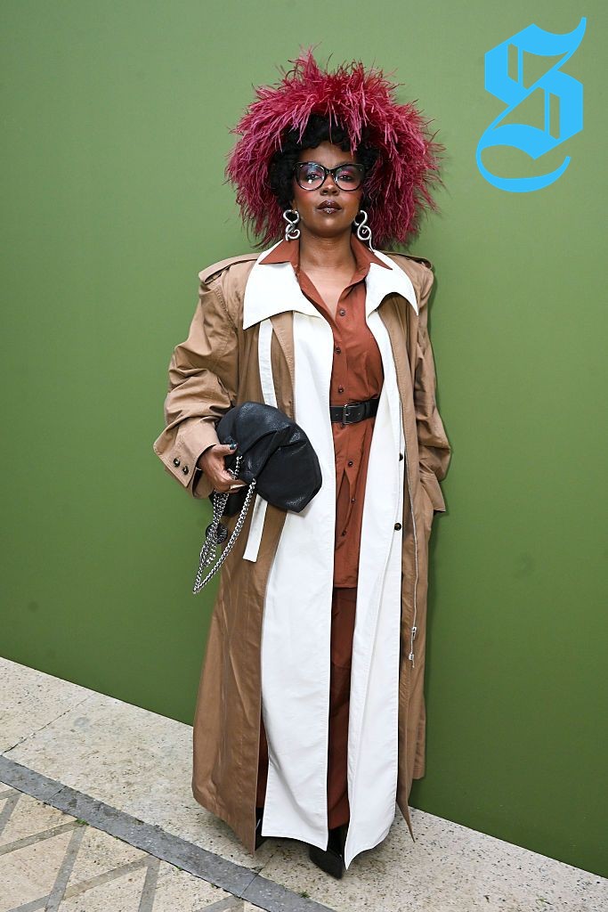 Lauryn Hill wearing a sophisticated long tan coat at Stella McCartney presentation.