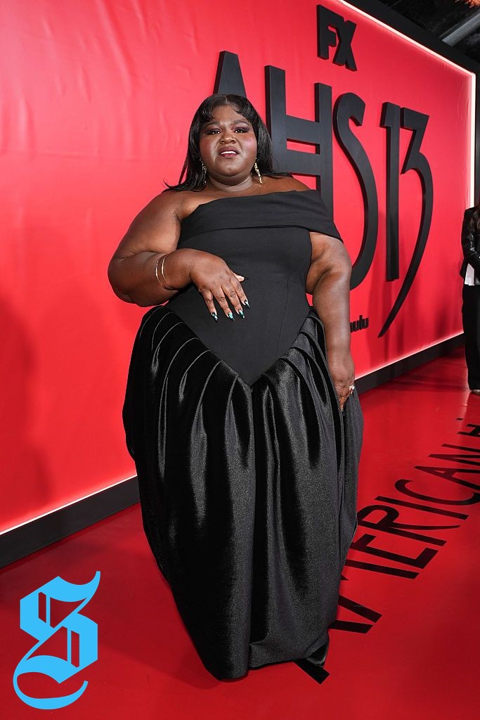 Gabourey Sidibe wearing an elegant off-the-shoulder black gown.