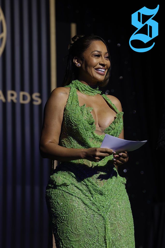 La La Anthony in a green sequined gown at an award dinner.