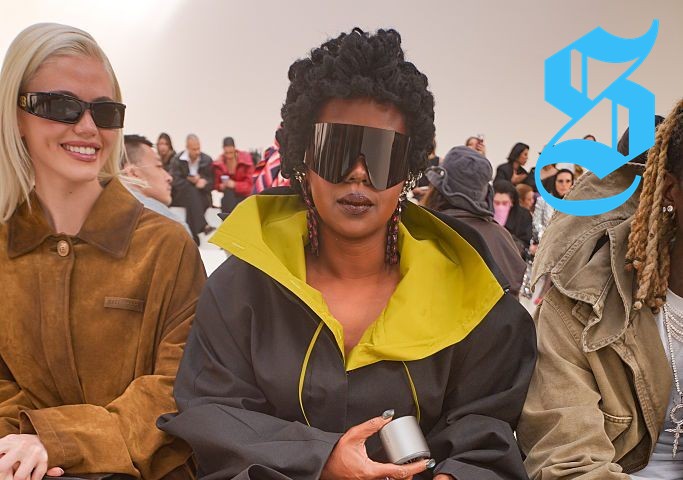 Lauryn Hill in an oversized black coat at Balenciaga show.